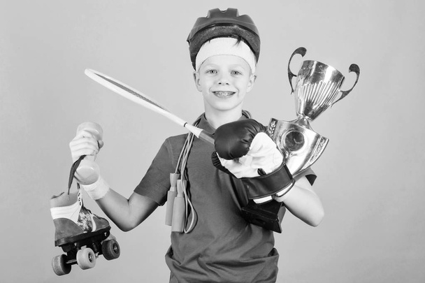 Succeed in everything. Athlete successful boy sport equipment jump rope boxing glove tennis racket roller skate and golden goblet. Success and award. Success in sport. Proud of achieved success - Фото, зображення