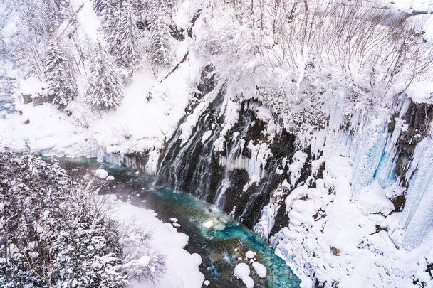 Beautiful outdoor nature landscape with shirahige waterfall and bridge in snow winter season Hokkaido Japan - Photo, Image