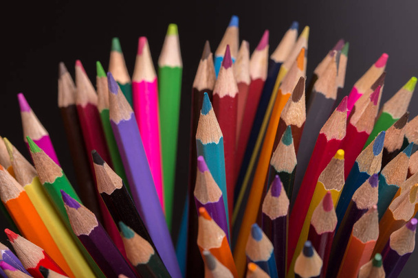Wooden colorful pencils, on a dark background - 写真・画像