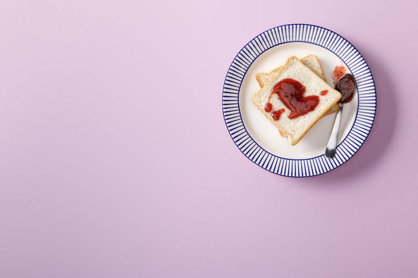 top view of toasts with jam on violet background - Foto, imagen