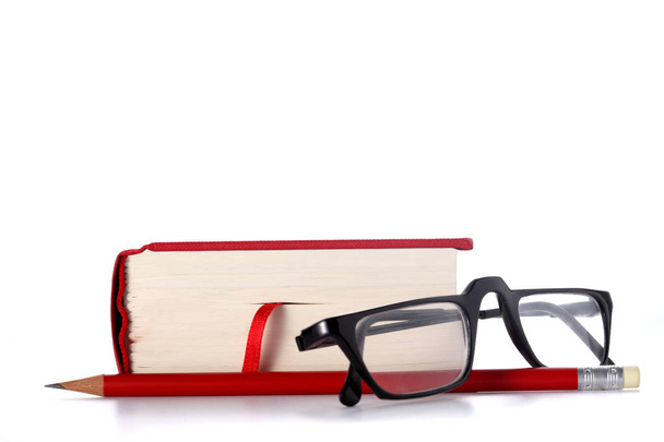 red book, eye glasses and a red pencil isolated on white background with copy space for your text - Photo, Image