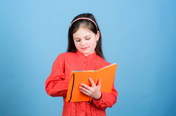 Homework exercise. Write composition. Literature club. Personal diary. Study and learn. Poetry author. Girl hold book and pen blue background. Kid writing book. Book concept. Development education - Фото, зображення