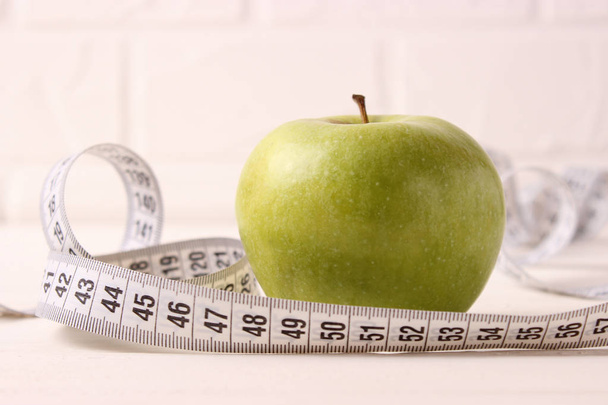 apple and measuring tape on a colored background side view. - Photo, image