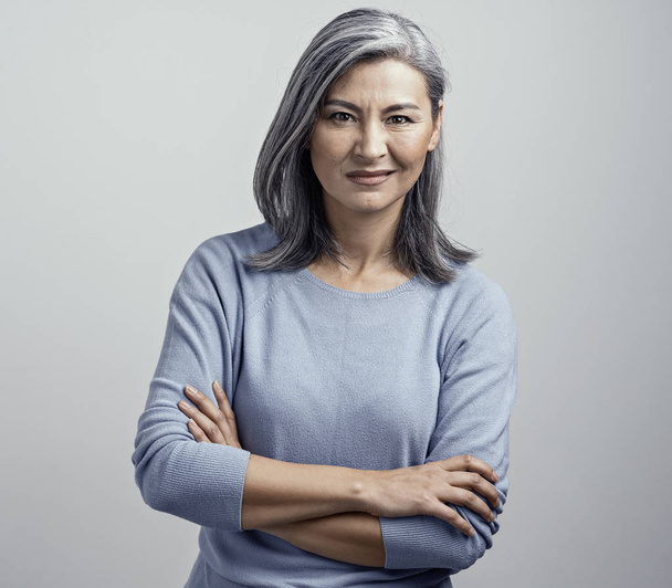 Asian senior woman with crossed arms shows dissproval - Fotografie, Obrázek