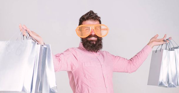 Man bearded hipster with lot shopping bags. Shopping on black friday. Happy shopping with bunch paper bags. Shopping addicted consumer. Profitable deal. How to get ready for your next vacation - Fotoğraf, Görsel