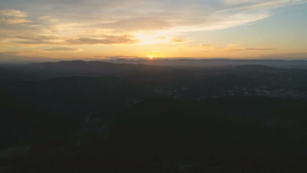 Flying back slowly over mountains. Beautiful view of clouds and amazing golden hour sunset. Aerial cinematic 4K drone footage - Footage, Video