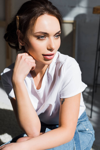 pensive young woman in white t-shirt thinking at home - Foto, Bild