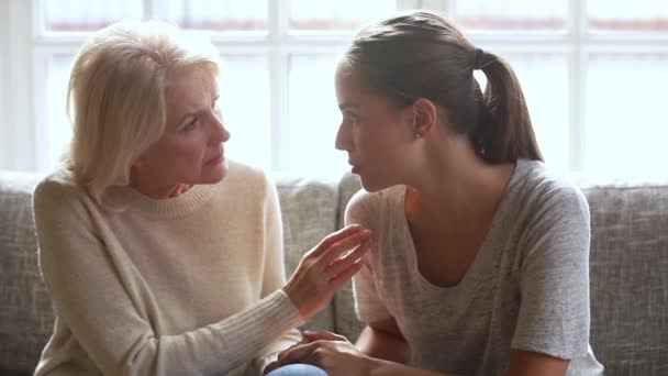 Worried old mother listening to young sad daughter sharing problems - Imágenes, Vídeo