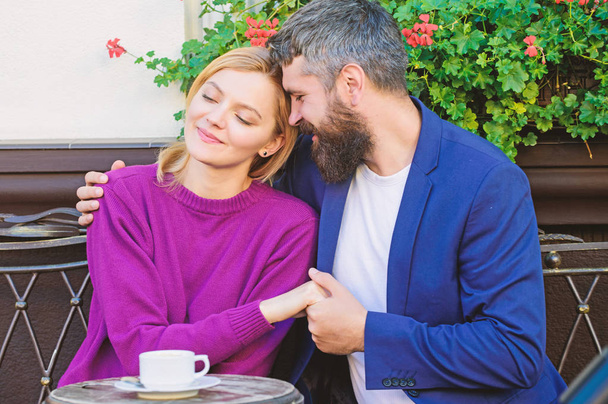 brutal bearded hipster man and woman drink coffee. woman and man with beard relax in cafe. Couple in love on romantic date. First meet of woman and mature man. Morning coffee. Feeling happiness - Φωτογραφία, εικόνα