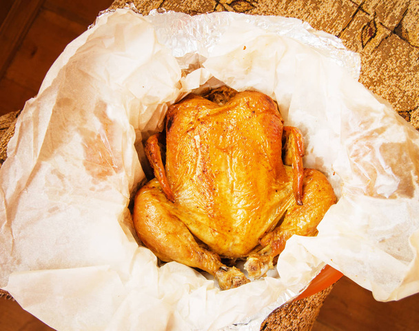 frango inteiro grelhado com pele dourada crocante em pergaminho branco, vista superior, close-up
 - Foto, Imagem