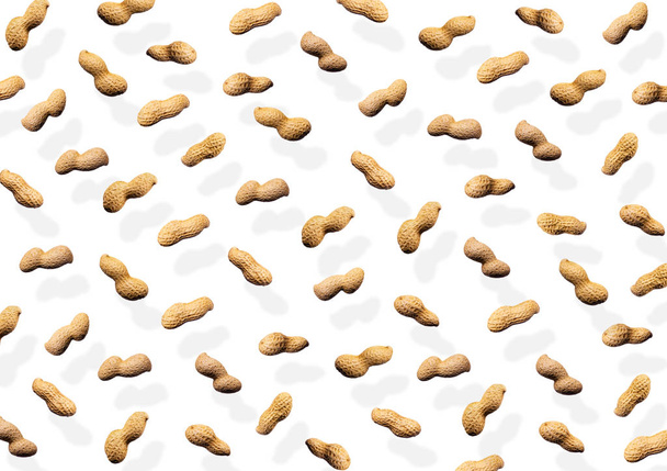 lying peanuts on a white background - Valokuva, kuva