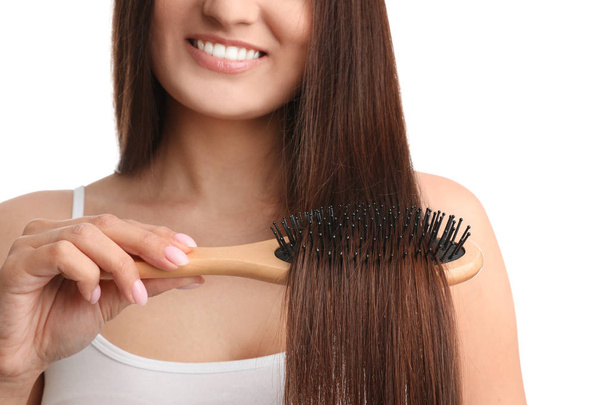 Woman with hair brush on white background, closeup - Фото, зображення