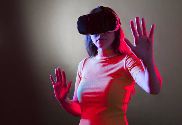 Young girl with VR goggles on head - Фото, зображення