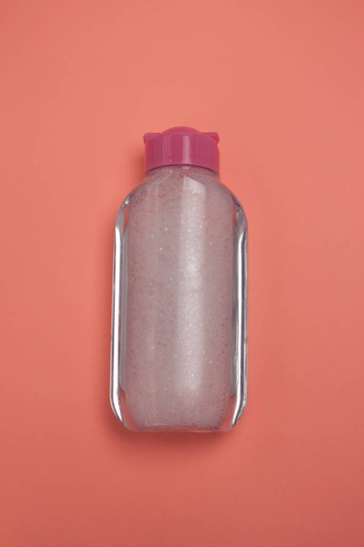 Skincare cosmetic bottle, product for cleansing and make-up remove, top view, pastel color background, minimalistic. - 写真・画像
