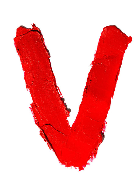 Handwritten big english capital letter V made of smudged red lipstick isolated on white background - Фото, изображение