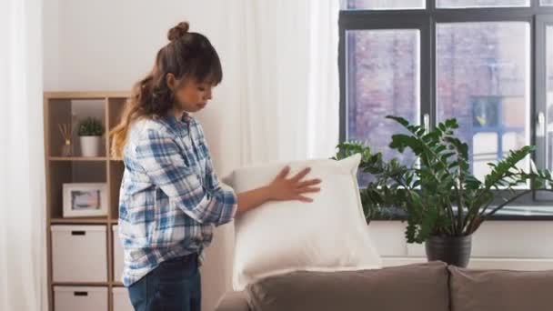 asian woman arranging sofa cushions at home - Felvétel, videó