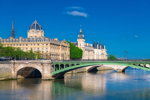 Paris, the Notre-Dame bridge, the Conciergerie on the ile de la Cite, with the Sainte-Chapelle in background  - Photo, Image