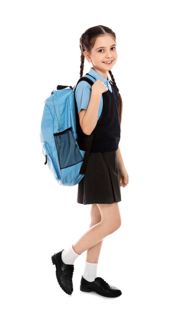 Full length portrait of cute girl in school uniform with backpack on white background - Фото, зображення