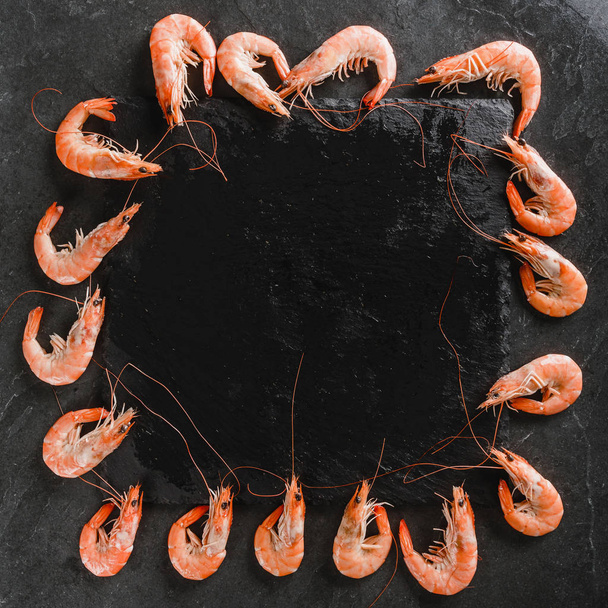 Fresh raw prawns or red shrimps lying around the slate stone on  - Photo, Image