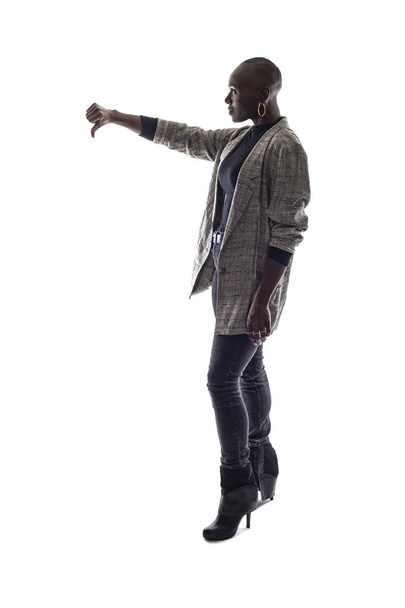 Black female African American model on a white background.  She is holding thumbs down in disapproval - Photo, image