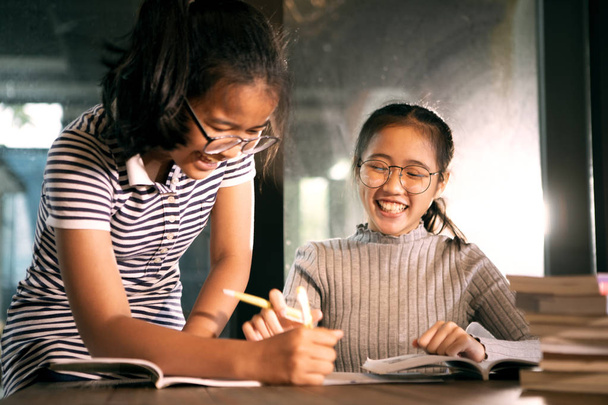 two asian girl laughing with happiness emotion doing school home - Photo, Image