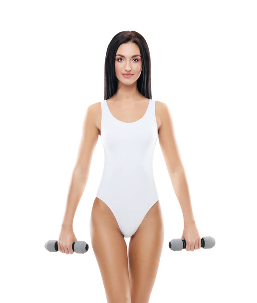 Fit and beautiful woman in swimsuit. Sporty girl with dumbbells. Fitness, diet and healthy lifestyle concept. - Фото, изображение