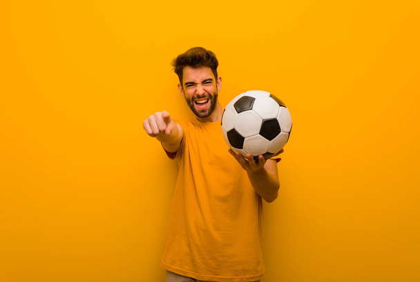 Young soccer player man cheerful and smiling - Valokuva, kuva