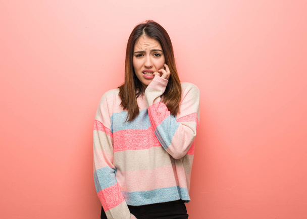 Young cute woman biting nails, nervous and very anxious - Foto, imagen