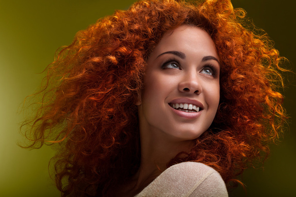 Red Hair. Beautiful Woman with Curly Long Hair. High quality ima - 写真・画像