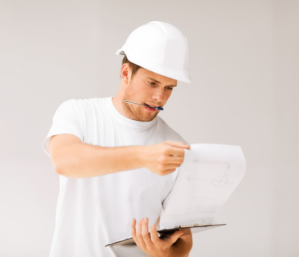 Male architect looking at blueprint - Фото, зображення