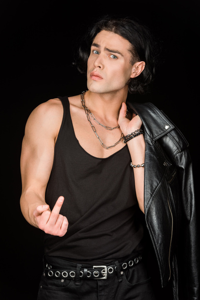 handsome man showing middle finger and holding leather jacket isolated on black  - Фото, зображення