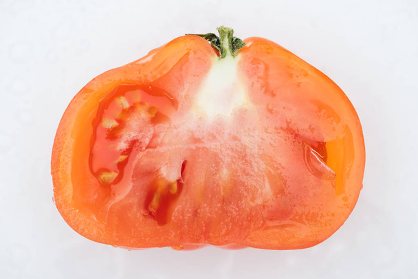 top view of red fresh tomato half isolated on white - 写真・画像