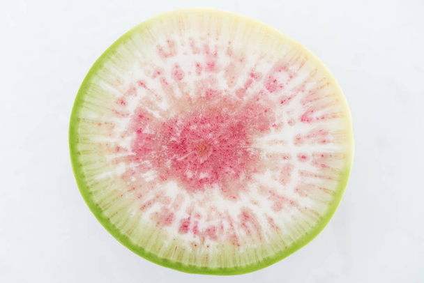 top view of cut raw purple fresh watermelon radish slice on white background - Zdjęcie, obraz