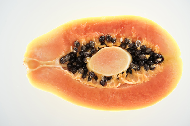 top view of ripe juicy papaya half with black seeds isolated on white - Foto, imagen