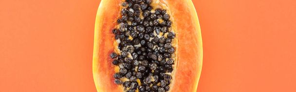 panoramic shot of ripe exotic papaya half with black seeds isolated on orange with copy space - Fotoğraf, Görsel