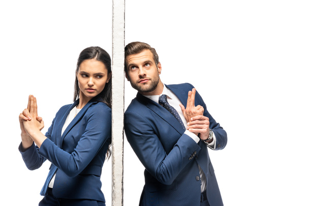 businessman and businesswoman separated by wall making gun gestures isolated on white - Photo, Image