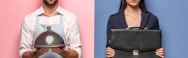 panoramic shot of man in apron with Serving Tray and businesswoman with briefcase on blue and pink - Photo, Image