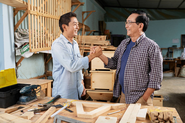 Carpenters greeting each other before starting work - Photo, Image