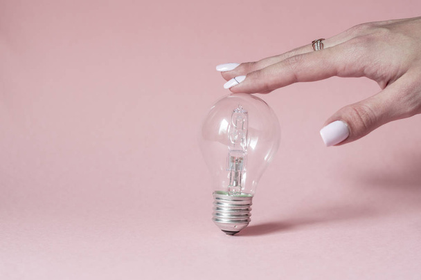 Close up view of white light bulb isolated on pink. - Foto, immagini