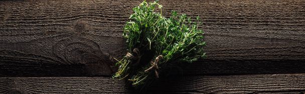 top view of green fresh thyme on wooden brown rustic table, panoramic shot - Zdjęcie, obraz