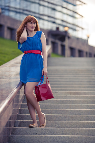 Beautiful woman standing on the stairs - 写真・画像