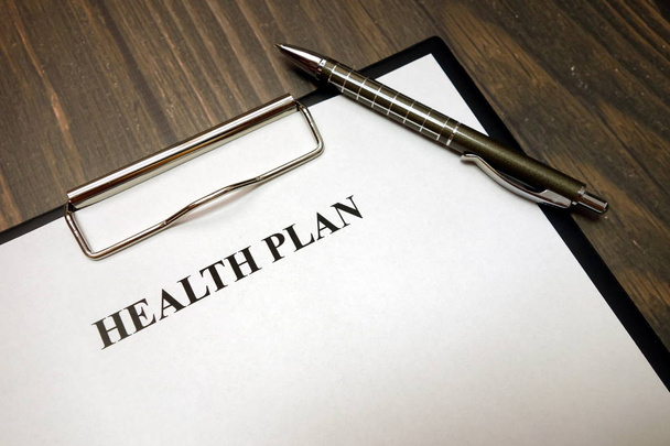 Clipboard with health plan and pen on desk - Photo, Image