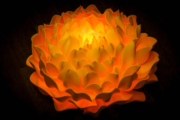 Large orange flower - lamp from EVA foam on a dark background - Foto, Imagem