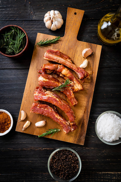 Fresh raw pork ribs ready for roasting with ingredients - Фото, зображення