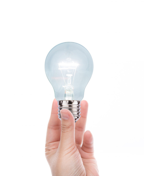 Hand with bulb isolated on white background - 写真・画像