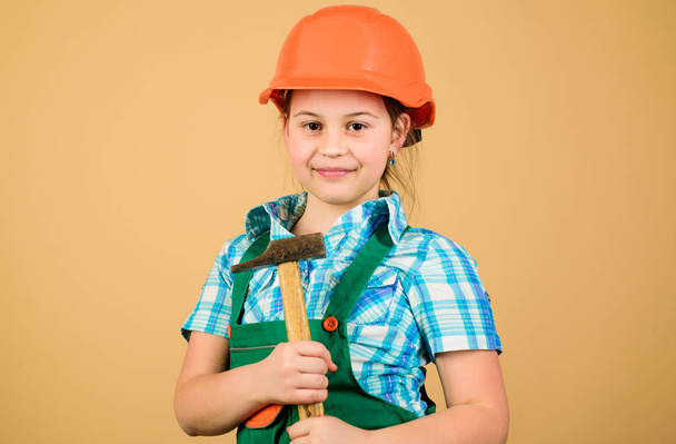 small girl repairing with hammer in workshop. Child care development. Future profession. Builder engineer architect. Kid worker in hard hat. Tools to improve yourself. Repair. This will be perfect - Fotoğraf, Görsel