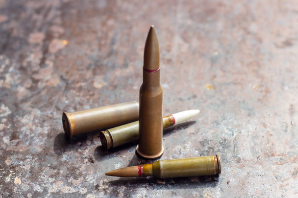 Weapon bullets on rusty metal background. Military industry, war, global arms trade and crime concept. - 写真・画像
