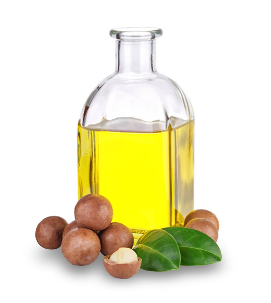 Olej macadamia w butelce i orzechach - Zdjęcie, obraz