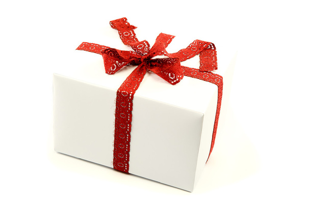 White box with red ribbon and bow isolated on a white background - Foto, Imagem