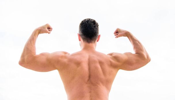 I am the best. Macho with naked back demonstrates his strength. muscular back man isolated on white. Sportsman celebrates victory. Sporty handome male training in gym. Athletic fitness competition - Φωτογραφία, εικόνα